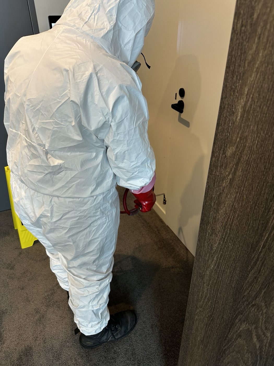 Envi pest control technician applying a treatment inside a property